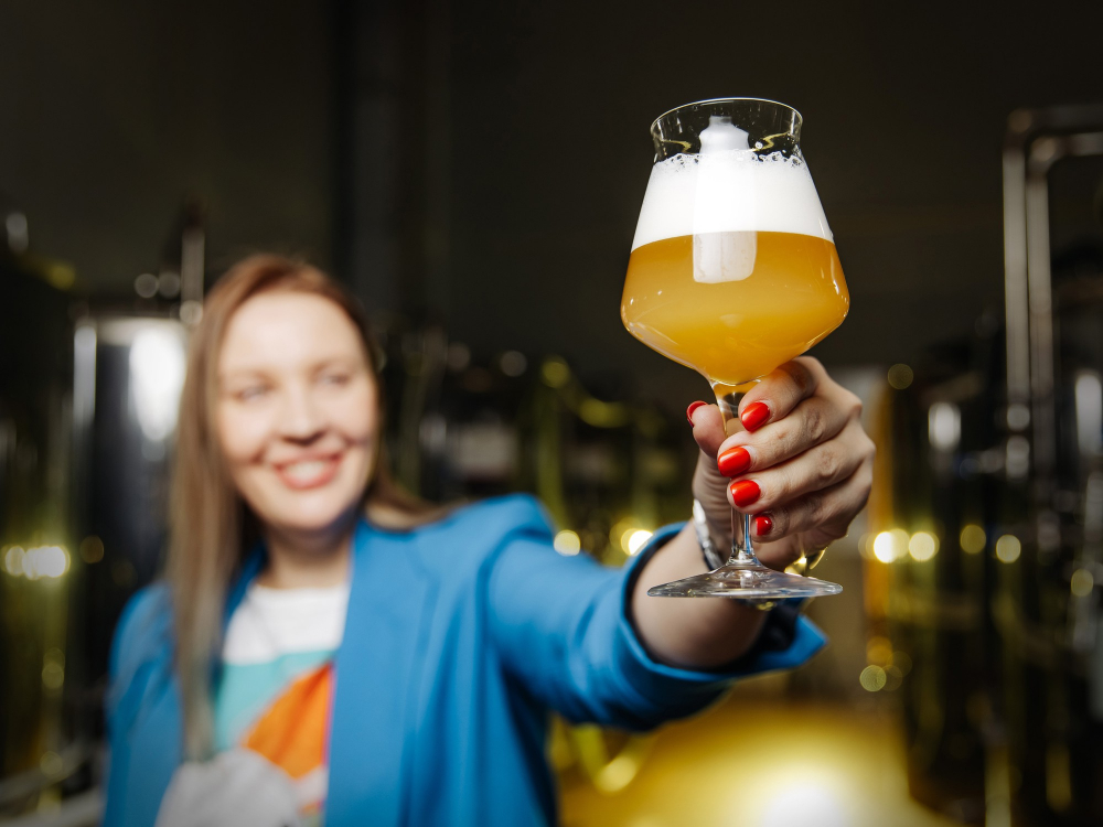 Smiling woman holding a glass of beer
